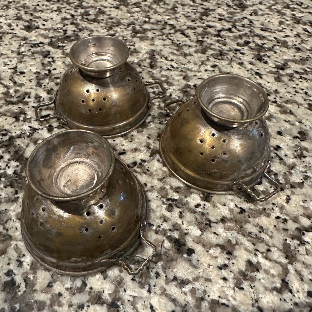 Three vintage tea strainers